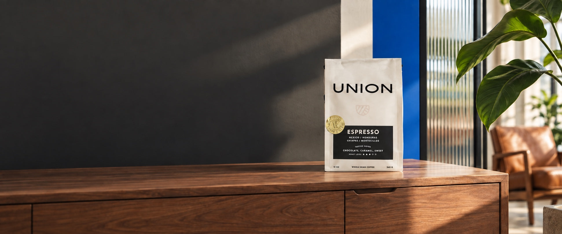 Union espresso on walnut with reeded glass, greenery, and blue accents